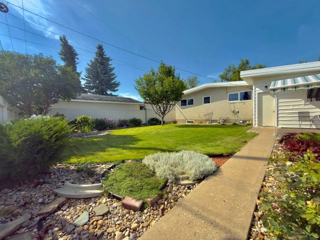 Backyard of 2610 20 Avenue S, with a lawn, garden beds and patio