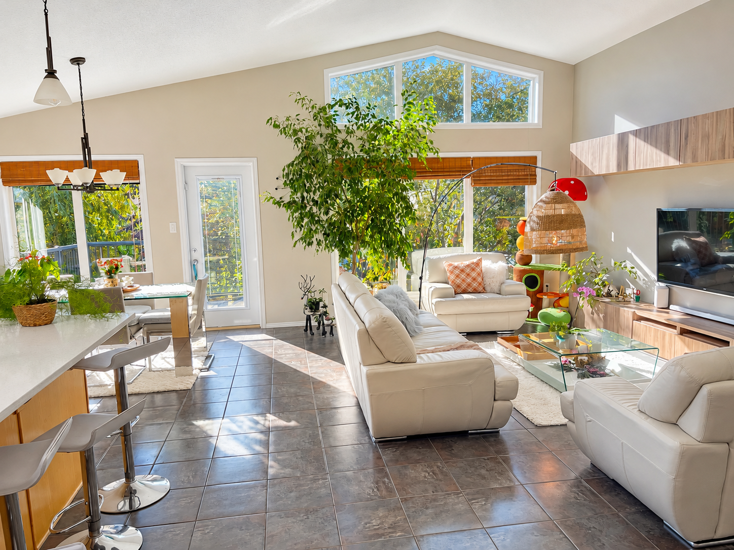 A sunlit open kitchen and living room; brightness, colour and clarity enhanced